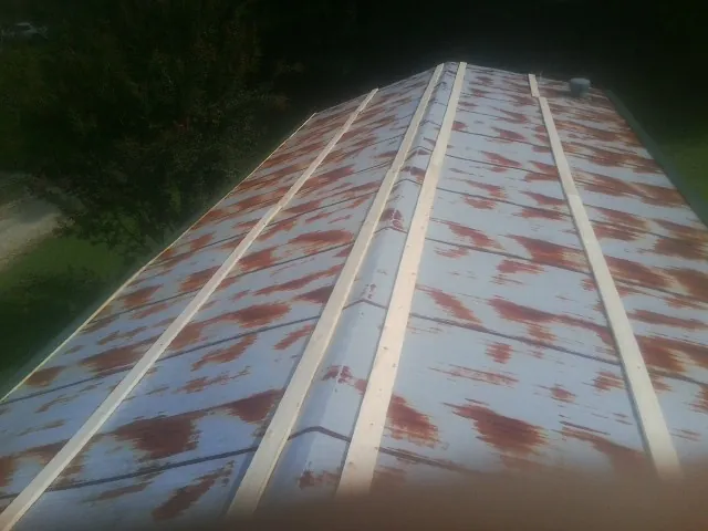 Rusted metal roof panels with new wood purlins before replacement — Storm Damage Roof Repair in Deerfield by Roofing Brothers