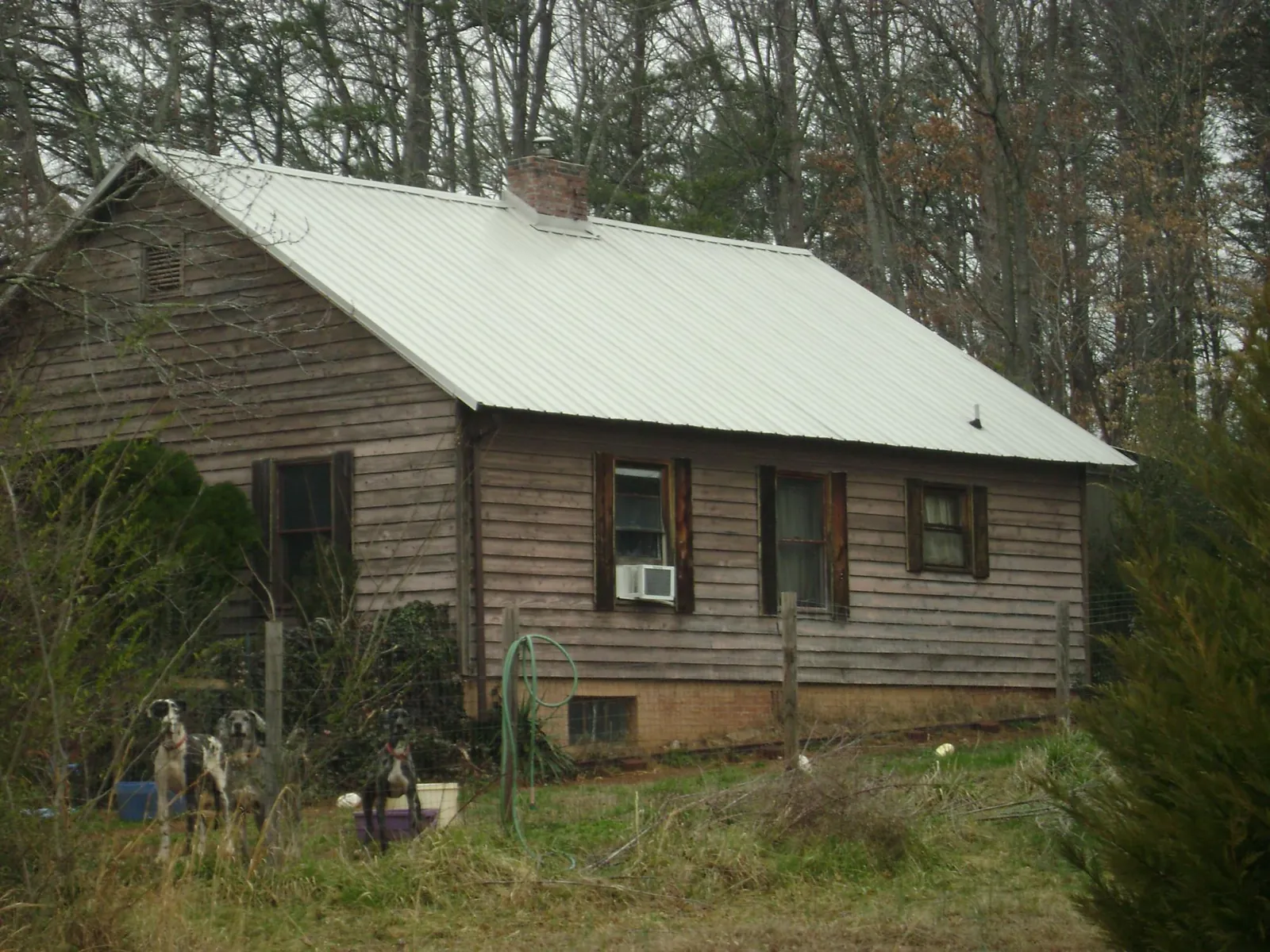 White metal roof on an old wood sided farmhouse, from a Metal Roof Installation job in Deerfield